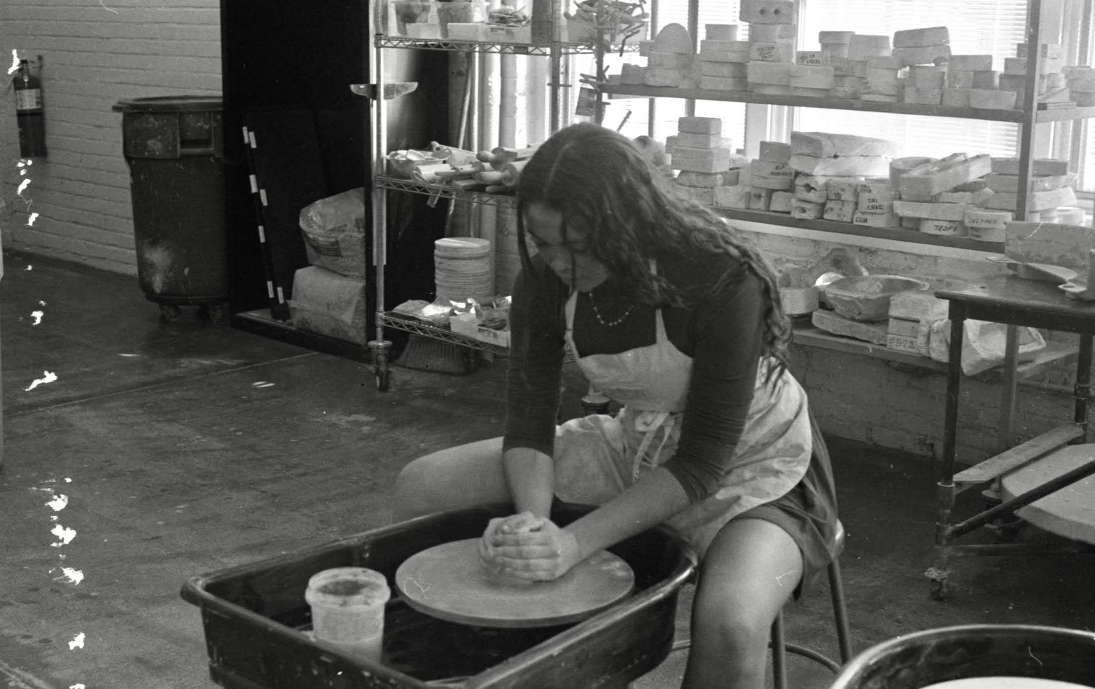 woman making ceramics at a pottery wheel