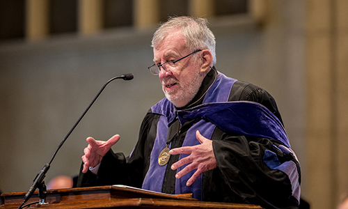 Dr. Stephen I. Hemenway speaking at podium in robes