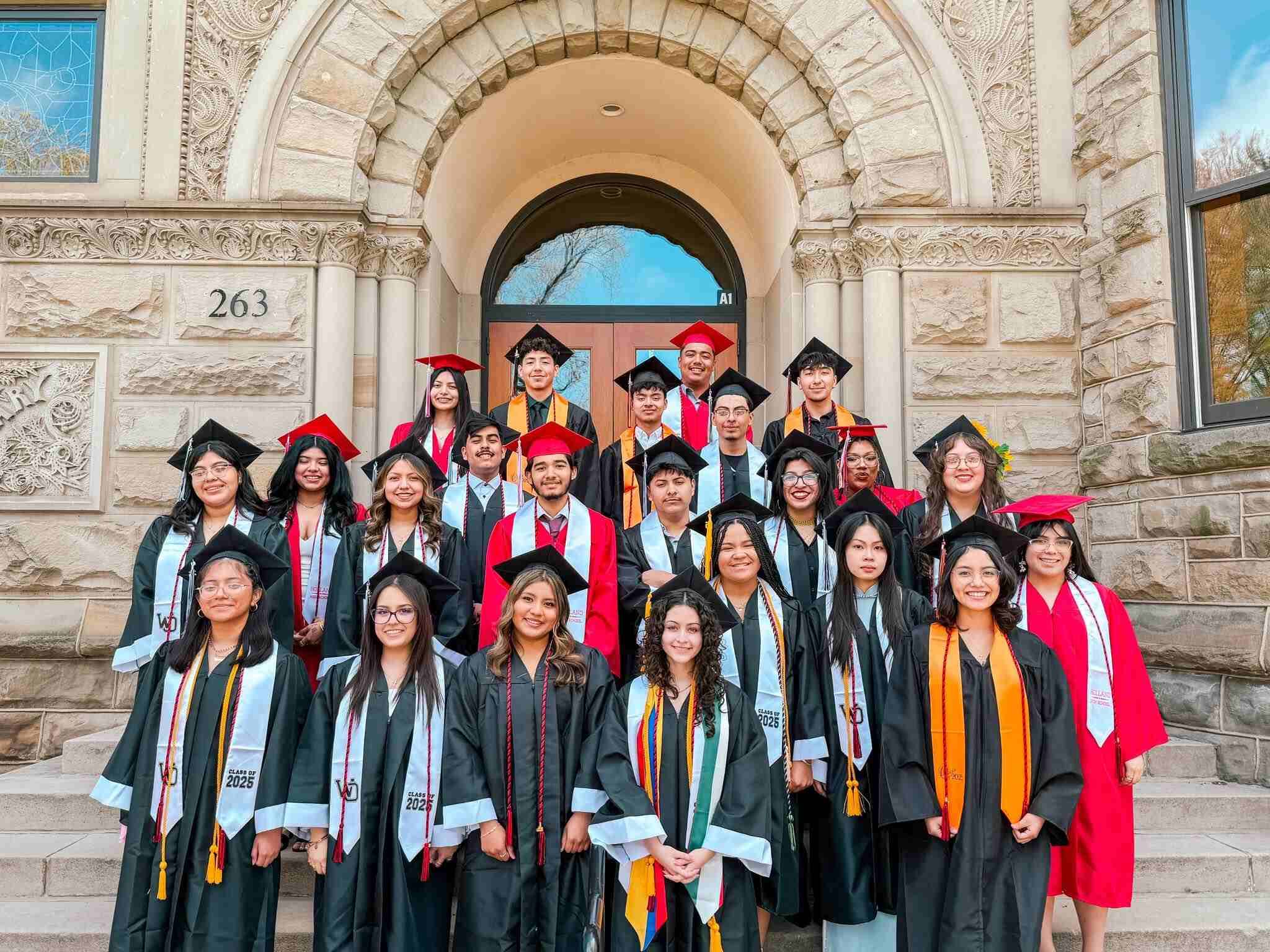 Upward Bound graduating class of 2024 in graduation robes and caps